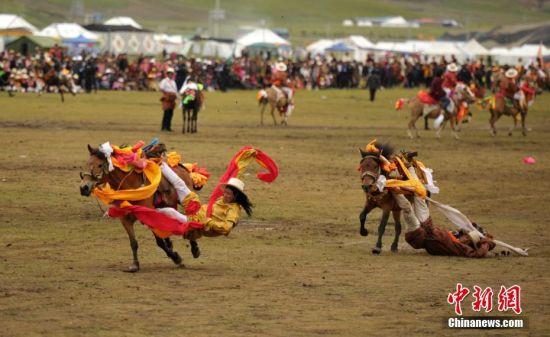 8月4日，四川理塘“八一”賽馬場上演一場精彩的馬術(shù)競技比賽，引來上萬民眾和游客觀賽。圖為牧民騎手進行五彩凌空競技。 中新社記者 劉忠俊 攝