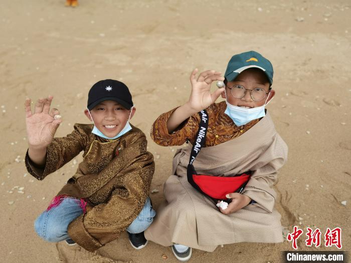 圖為西藏青少年在海邊拾貝殼。西藏航空 供圖