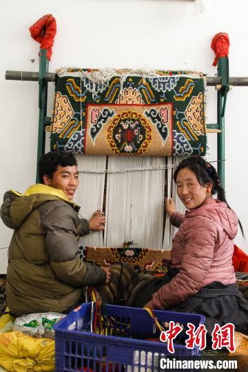 圖為1月15日，在日喀則市謝瑪氆氌農(nóng)村合作社，拉孜村一對夫婦在編織卡墊(資料圖)?！≮w朗 攝