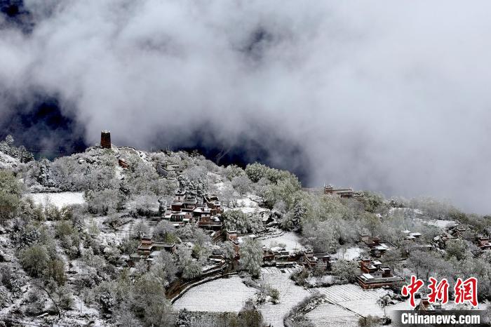 雪后的藏寨和碉樓構(gòu)成美麗的雪景。　降初澤郎 攝