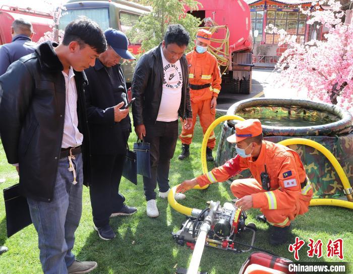 圖為森林消防員為護林員講解滅火裝備的使用方法。　昌都市森林消防支隊 供圖