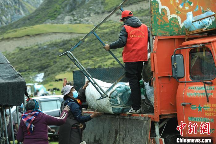 圖為工作人員幫助牧民們卸家具?！÷蹇?攝