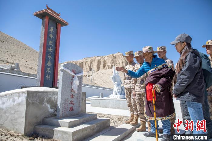 圖為在西藏阿里地區(qū)札達縣烈士陵園，82歲的次仁南杰老人為軍民代表講述新舊西藏的變化?！詵| 攝