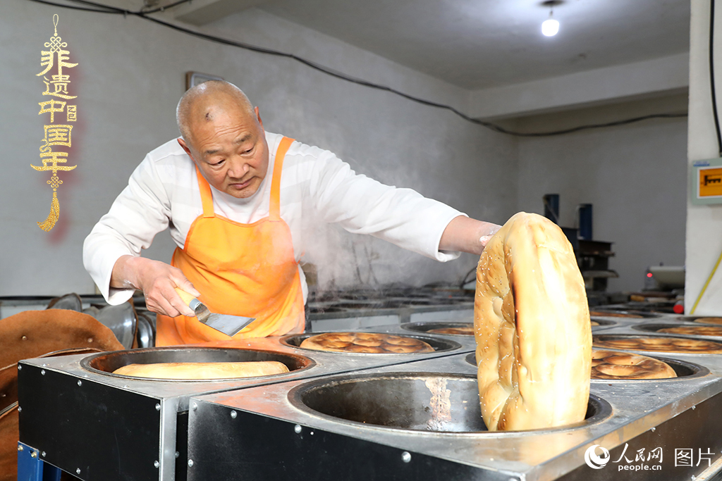 2025年1月23日，山東省臨沂市莒南縣一家傳統大餅作坊內，師傅們正忙著烤制當地人春節(jié)期間家家戶戶必備的、金黃誘人的莒南大餅。人民網記者 劉祺攝